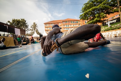 A man lying on the floor with shoes
